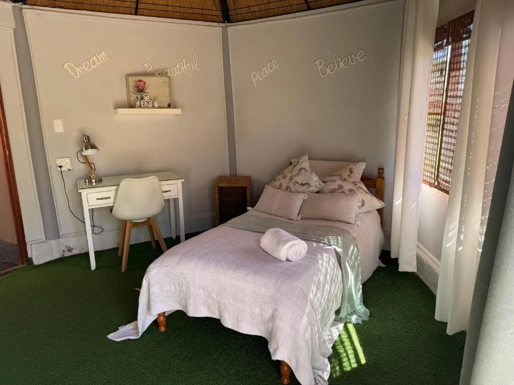 Cozy bedroom with queen bed, desk, and inspirational wall decals