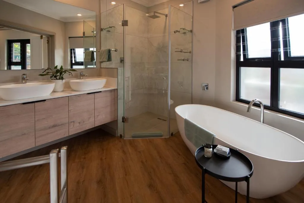 Modern bathroom with freestanding bathtub, double vanity, and walk-in shower