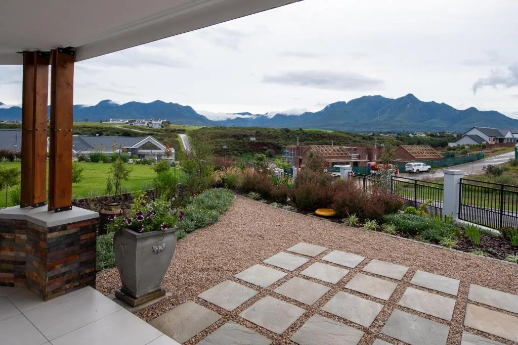 Spacious patio with mountain views, landscaped gardens, and modern architecture