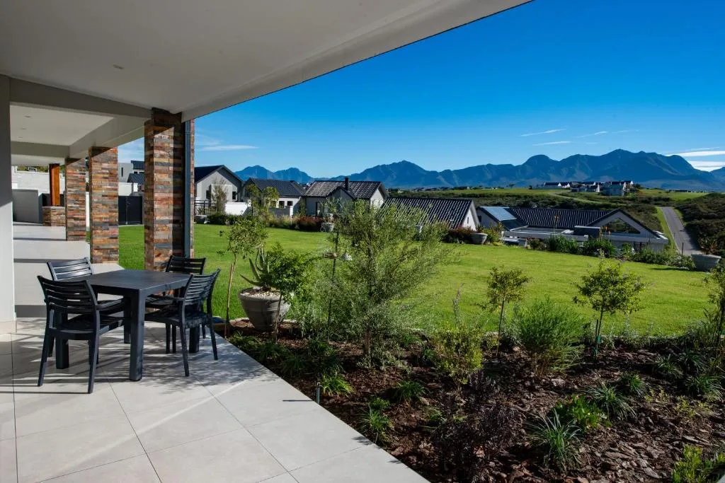 Covered patio with dining table overlooking mountains and valley landscape