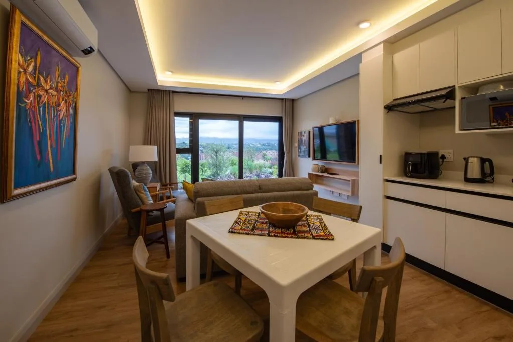 Modern open-plan lounge and dining area with panoramic mountain views and contemporary furnishings