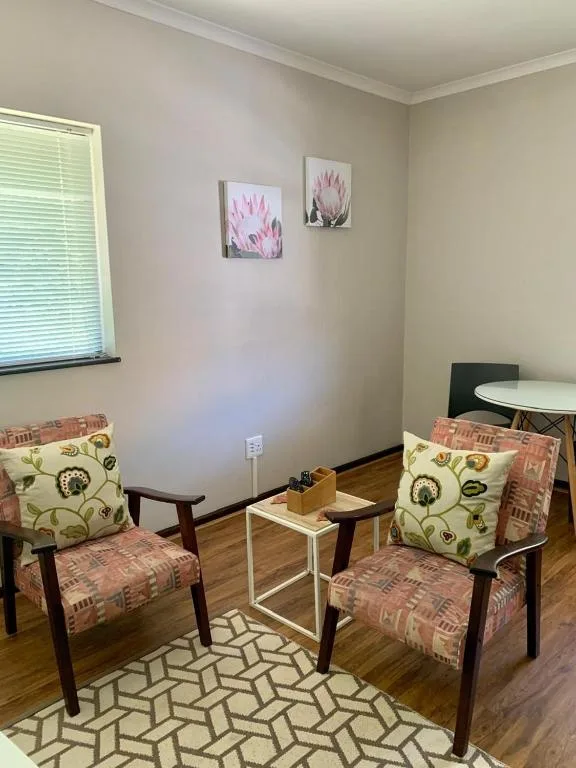 Cozy lounge area with two upholstered chairs and small side table