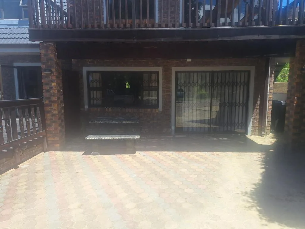 Brick building exterior with paved patio and glass sliding doors