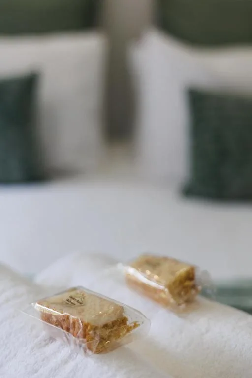 Luxury toiletries and amenities arranged on white bedding