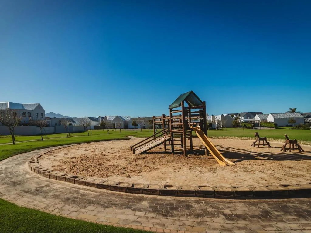 Playground with slide and climbing structure on manicured estate grounds