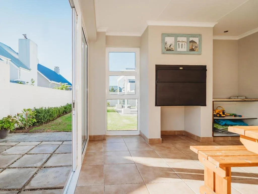 Bright interior lounge with wooden furniture and garden view