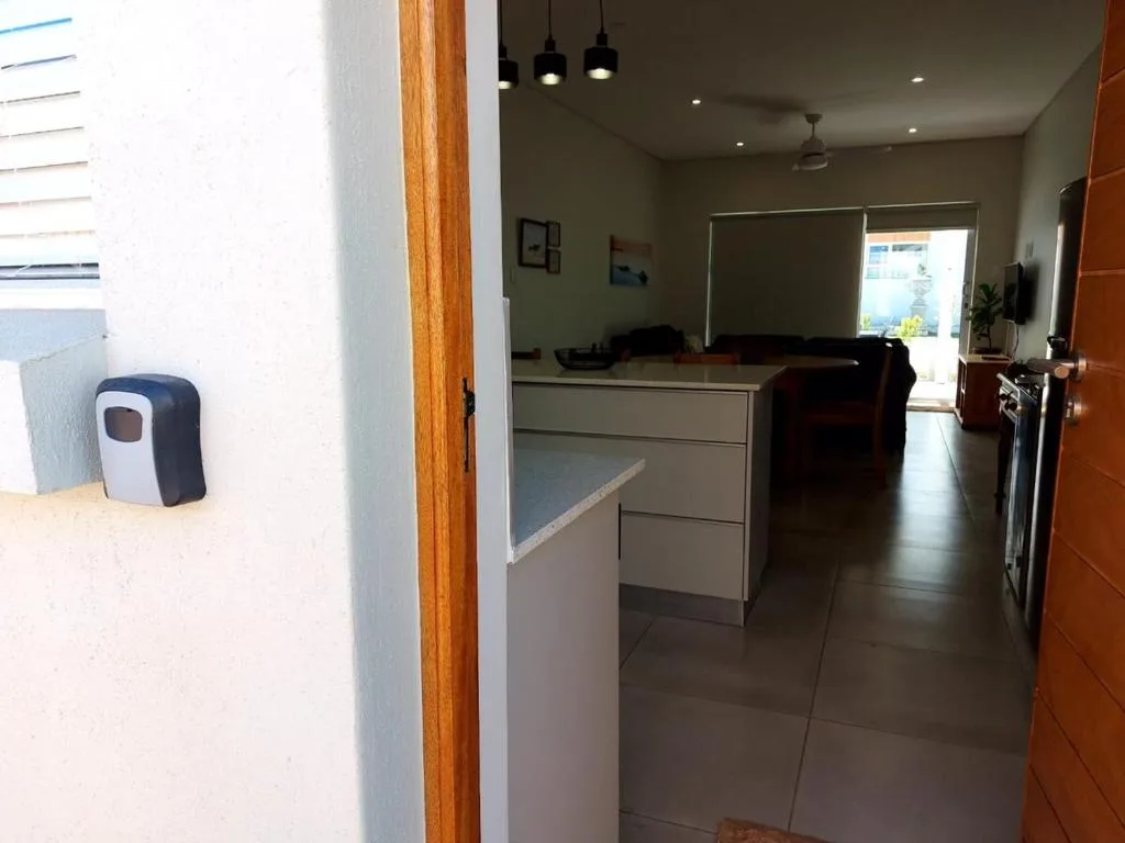 Modern kitchen with light cabinetry, pendant lighting, and open-plan layout view