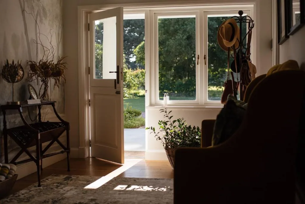 Bright lounge with French doors opening to garden views and countryside beyond