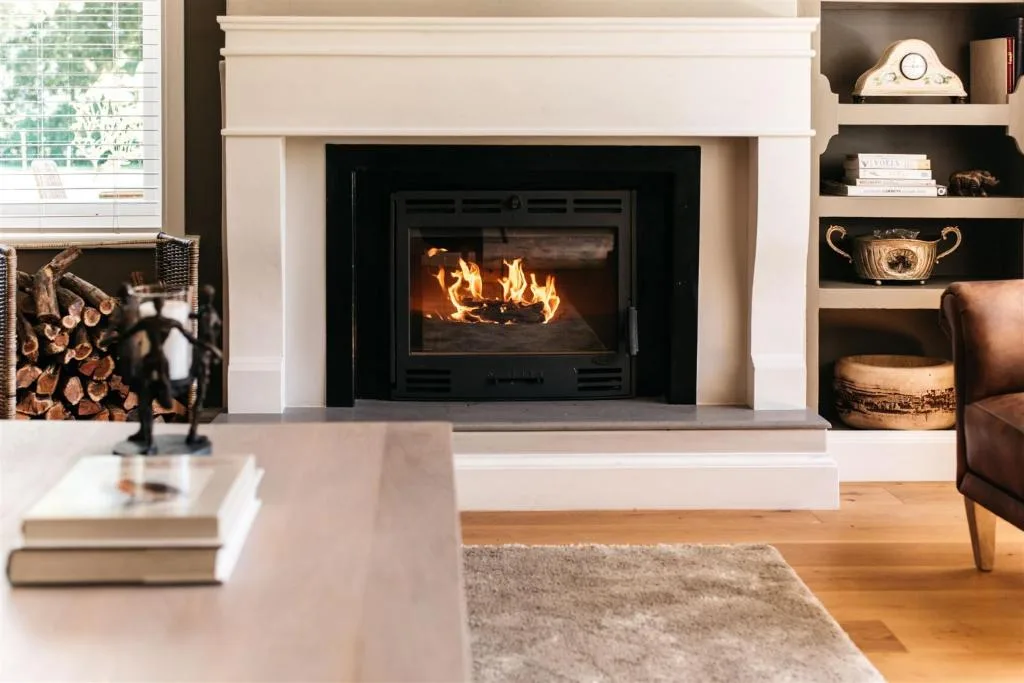 Modern lounge with fireplace, built-in shelving, and comfortable seating area