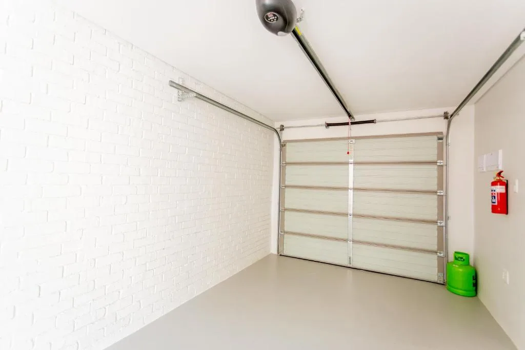 Clean modern garage interior with white brick walls and sectional door