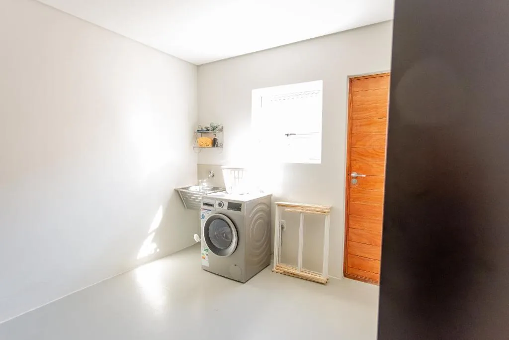 Modern laundry room with washing machine and storage cabinet